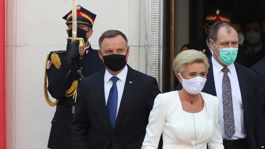 Poland's conservative President Andrzej Duda,left, and First Lady Agata Kornhauser-Duda, right leave the parliament building following the ceremony of Duda's swearing in for a second five-year term in Warsaw, Poland, August 6, 2020.