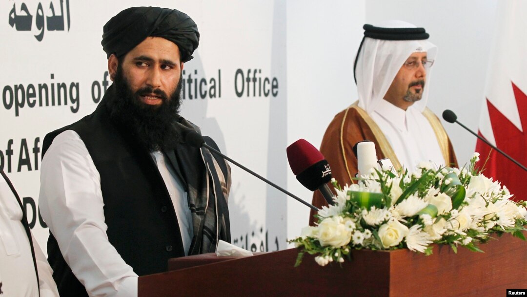 Muhammad Naeem (L), a spokesman for the Office of the Taliban of Afghanistan, speaks during the opening of the Taliban Afghanistan Political Office in Doha, June 18, 2013. 
