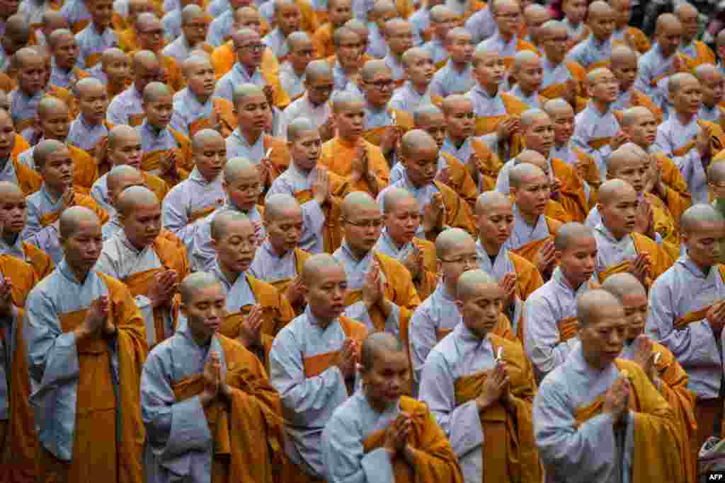 Buddhist monks pray for late Vietnam's President Tran Dai Quang at the Viet Nam Quoc Tu Pagoda in Ho Chi Minh City. Quang, a former police chief known as a tough politician and committed communist with little tolerance for dissent, died on September 21 aged 61 after a serious illness, state media reported.