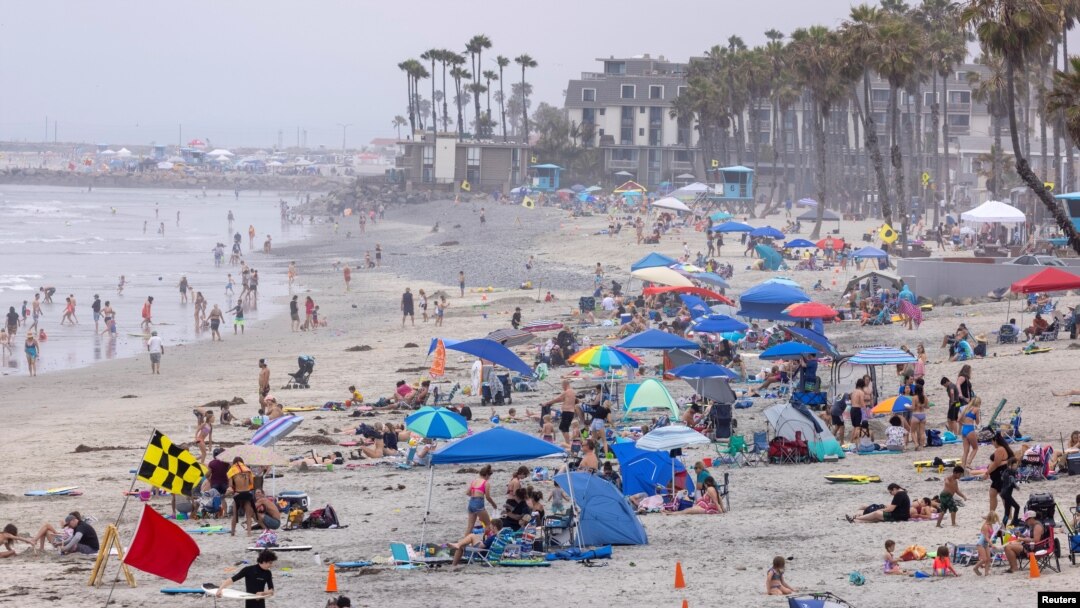 People gather at the beach to cool-off as a heatwave continues in Oceanside, California, U.S., June 17, 2021. REUTERS/Mike Blake