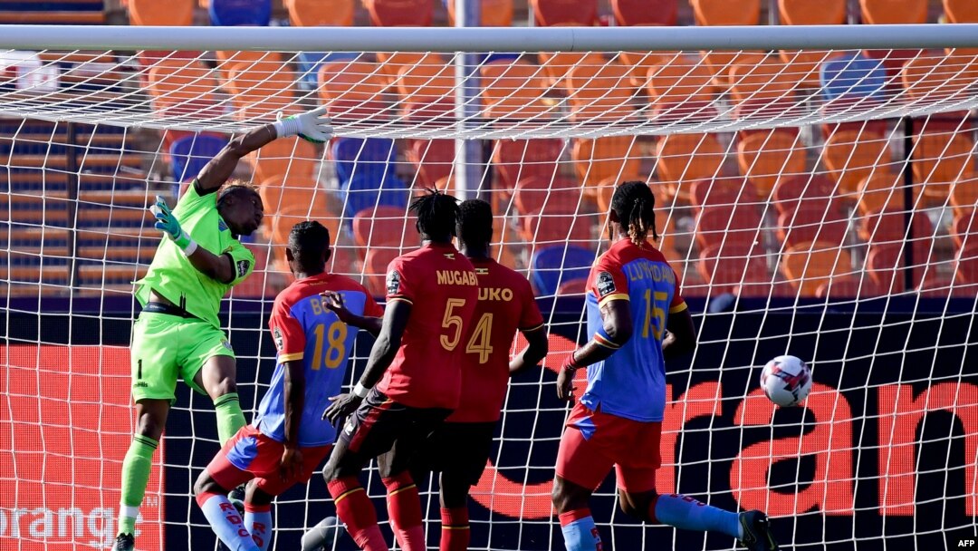 Golikipa wa timu ya taifa ya Congo Léopards Ley Matampi akiukosa mpira huku mshambuliaji wa Uganda Patrick Kaddu akifunga bao wakati wa michuano ya kombe la mataifa ya Afrika CAN 2019 mjini Cairo, Misri 22 Juni 2019.
