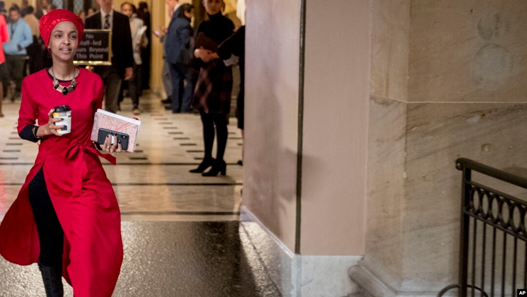 Rep. Ilhan Omar, Democrat-Minnesota, center, walks through the halls of the Capitol Building in Washington, Jan. 16, 2019.