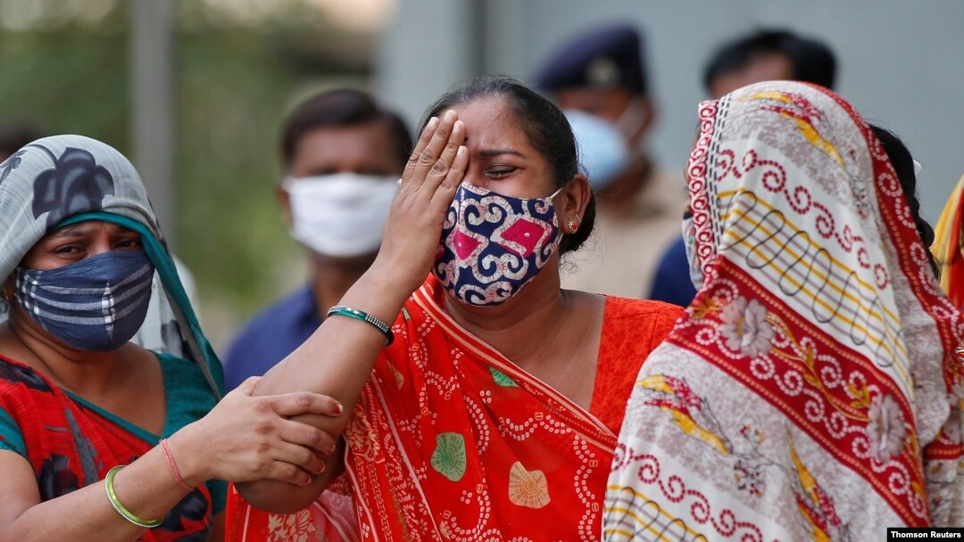 A woman grieves after her husband died from the coronavirus, outside a mortuary of a COVID-19 hospital in Ahmedabad, India, May 8, 2021.
