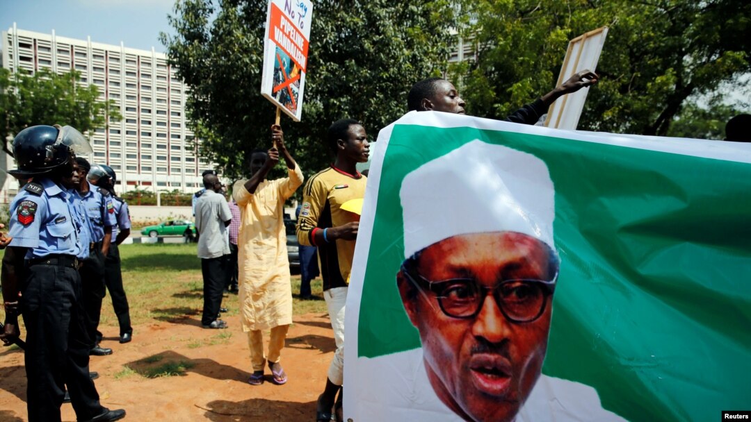 Wasu magoya bayan shugaba Buhari a rike da hotonsa yayin wani gangamin nuna goyon bayansa da aka yi a ranar 11 ga watan Agusta 2017 a Abuja