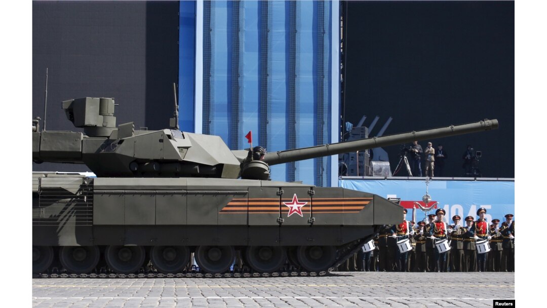 A Russian serviceman holds a red flag onboard a T-14 Armata tank after it stopped during a rehearsal for the Victory Day parade in Red Square in central Moscow, May 7, 2015.