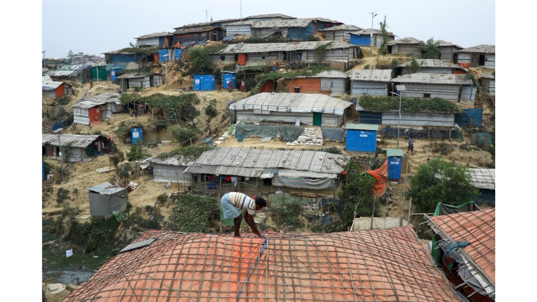FILE - A Rohingya refugee repairs the roof of his shelter at the Balukhali refugee camp in Cox's Bazar, Bangladesh, March 5, 2019.