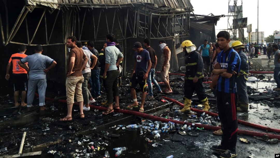 FILE - Security forces and civilians gather at the scene of a suicide car bomb attack in the capital's eastern Shiite-dominated New Baghdad neighborhood, Iraq, April 25, 2016.
