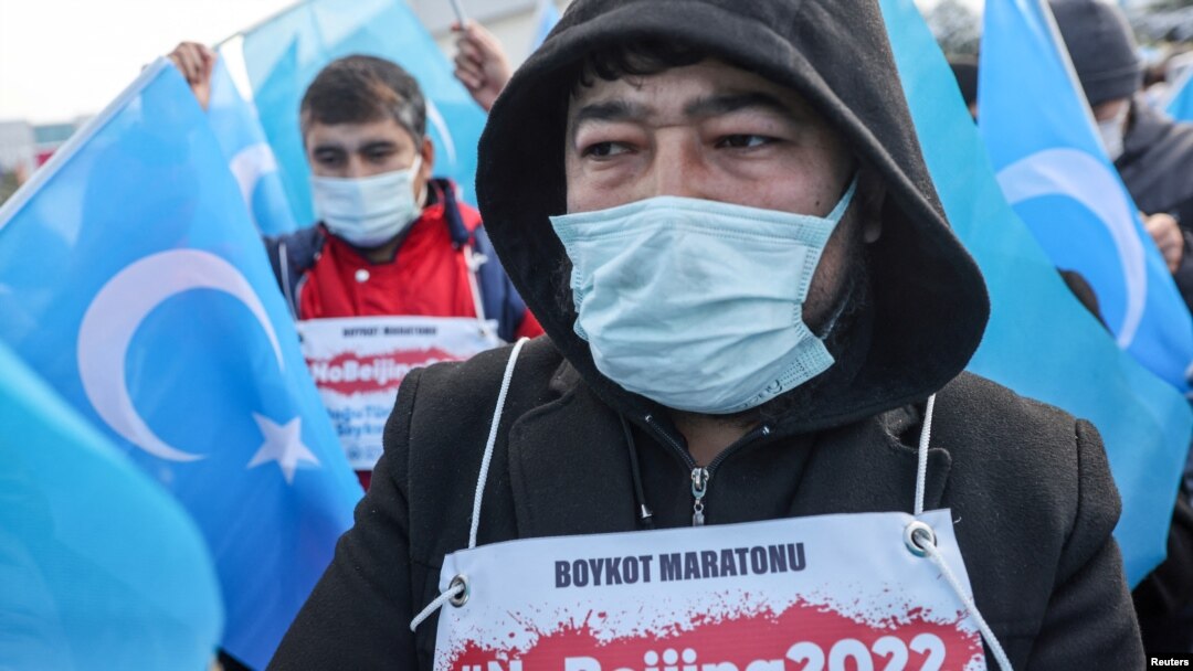 FILE - People from China's Uyghur Muslim ethnic group protest outside the city's Turkish Olympic Committee building, calling for a boycott of the Winter Olympics in Beijing over China's treatment of the minority, in Istanbul, Turkey, Jan. 23, 2022. 