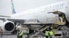 FILE - Workers unload a shipment of the Johnson & Johnson COVID-19 vaccine from an airplane at O. R. Tambo International Airport in Johannesburg, South Africa, Feb. 27, 2021.