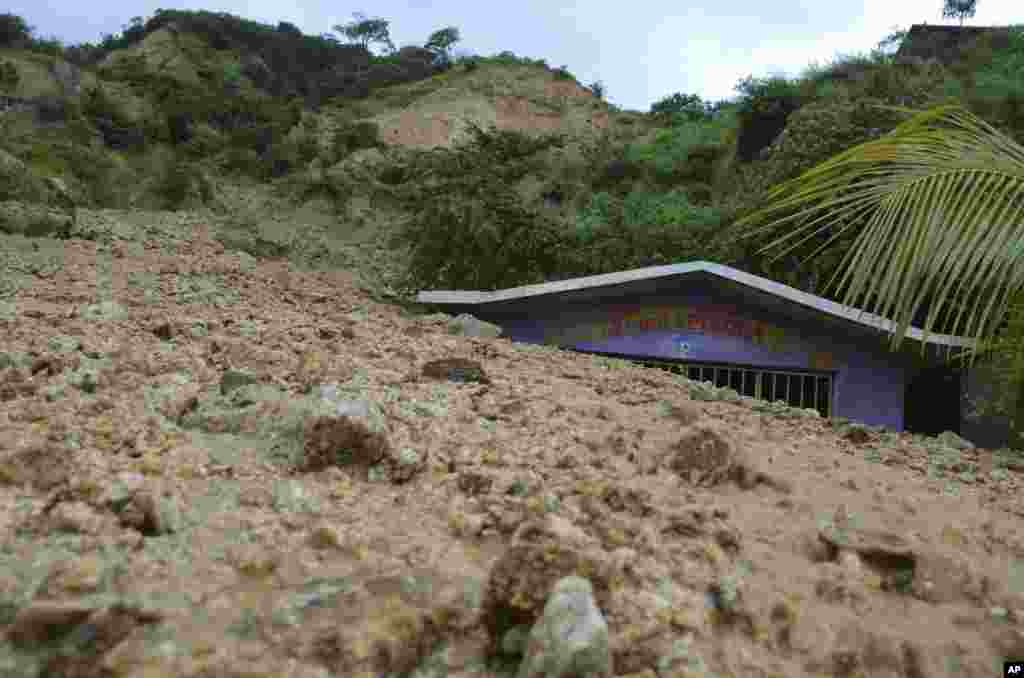 A small chapel is engulfed in rock and mud from a landslide brought on by Tropical Storm Manuel's heavy rains on the outskirts of Acapulco, Mexico, Sept. 16, 2013.