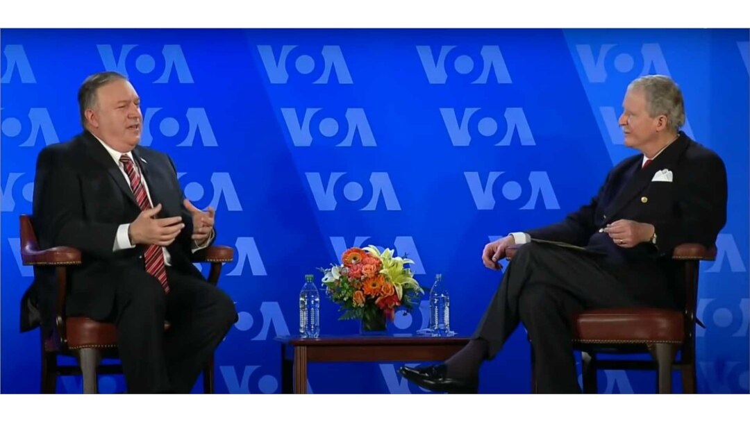 FILE - Secretary of State Michael Pompeo has a conversation with VOA Director Robert Reilly at the Voice of America headquarters in Washington, Jan. 11, 2021.