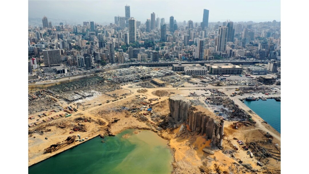 FILE - An aerial view taken Aug. 7, 2020, shows a partial view of the port of Beirut, the damaged grain silo and the crater caused by the colossal explosion three days earlier of a huge pile of ammonium nitrate.