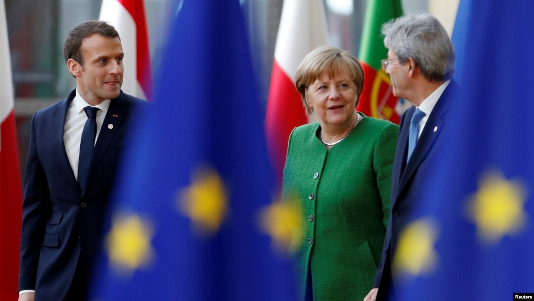French President Emmanuel Macron, Germany's Chancellor Angela Merkel and Italy's Prime Minister Paolo Gentiloni arrive at a European Union heads of state informal meeting in Brussels, Belgium, Feb. 23, 2018.