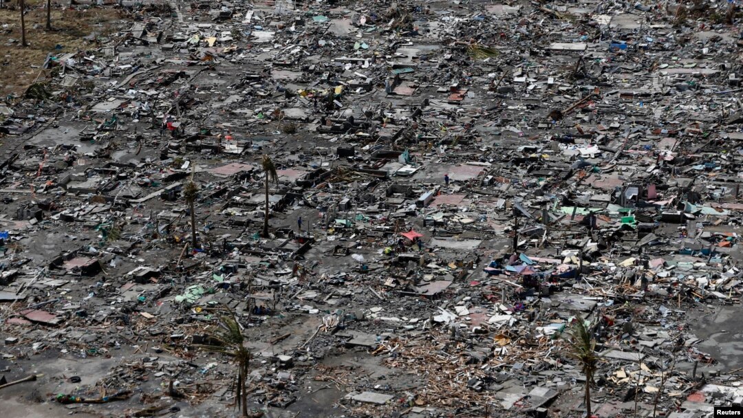 FILE - An aerial view of the ruins of houses after the devastation of super Typhoon Haiyan in Tacloban city in central Philippines, Nov. 11, 2013. 