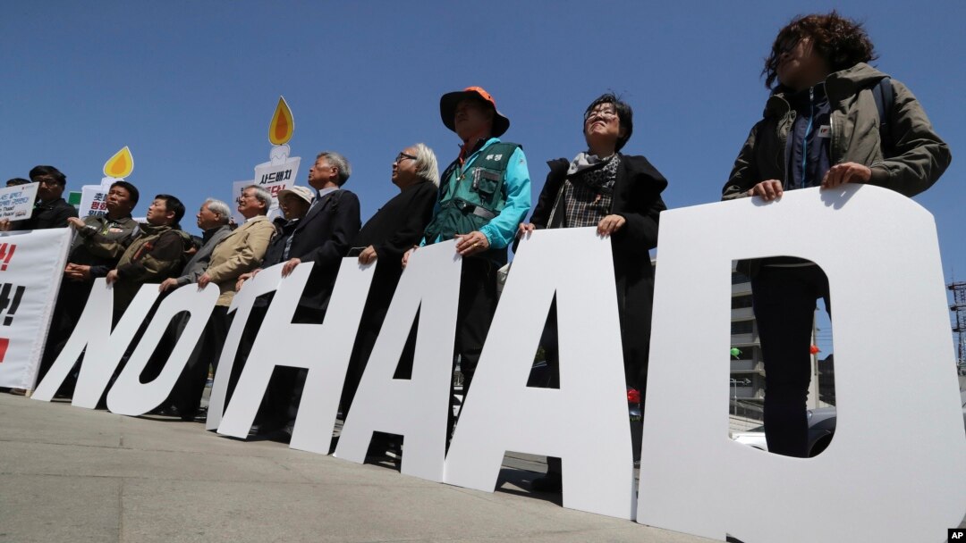 Protesters hold letters reading "NO THAAD" during a rally to oppose a plan to deploy an advanced U.S. missile defense system called Terminal High-Altitude Area Defense, or THAAD, near the U.S. Embassy in Seoul, South Korea, April 26, 2017. 