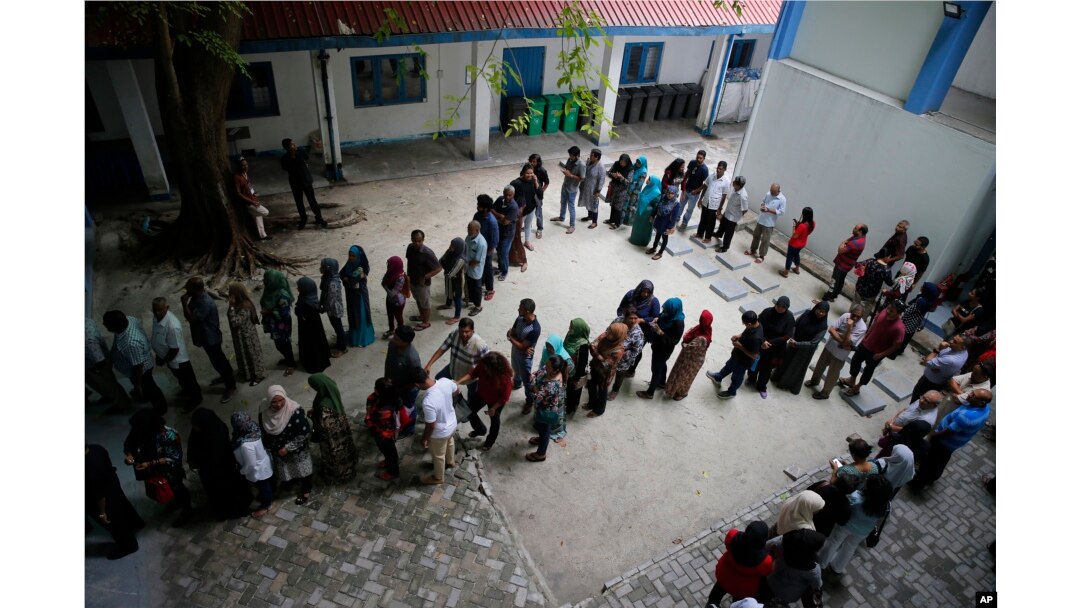 Maldivians queue at a polling station during presidential election day in Male, Sept. 23, 2018.