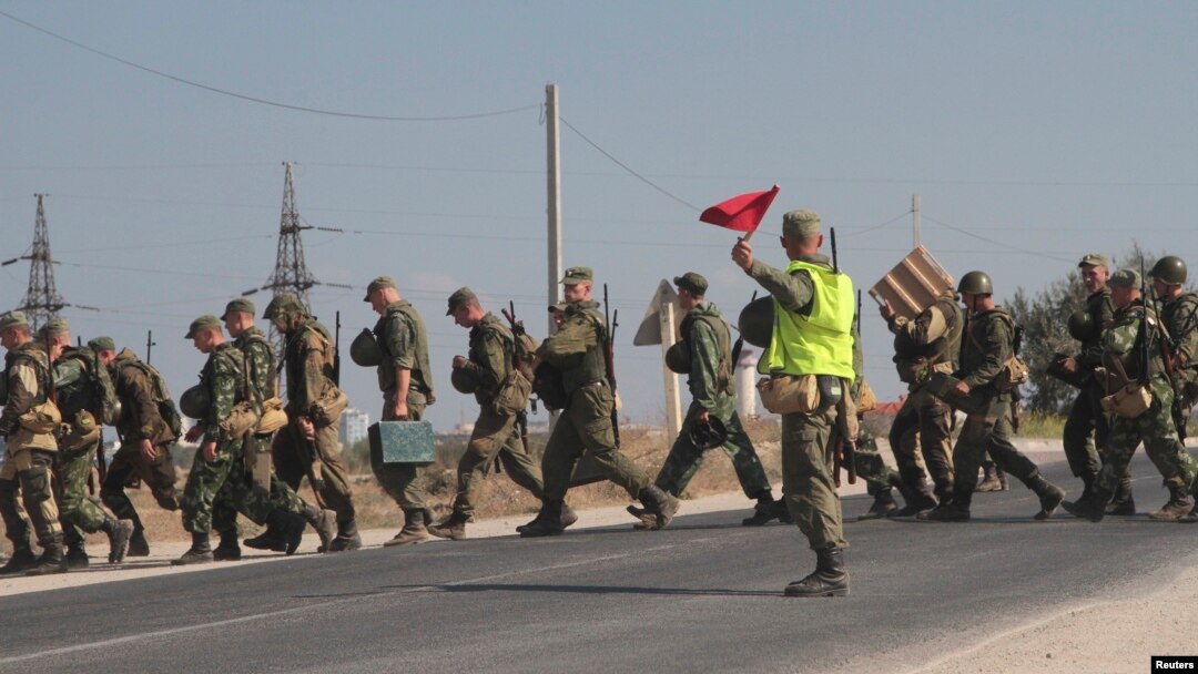 Russian marines cross a road in the Crimean port of Sevastopol, Sept. 17, 2014. 