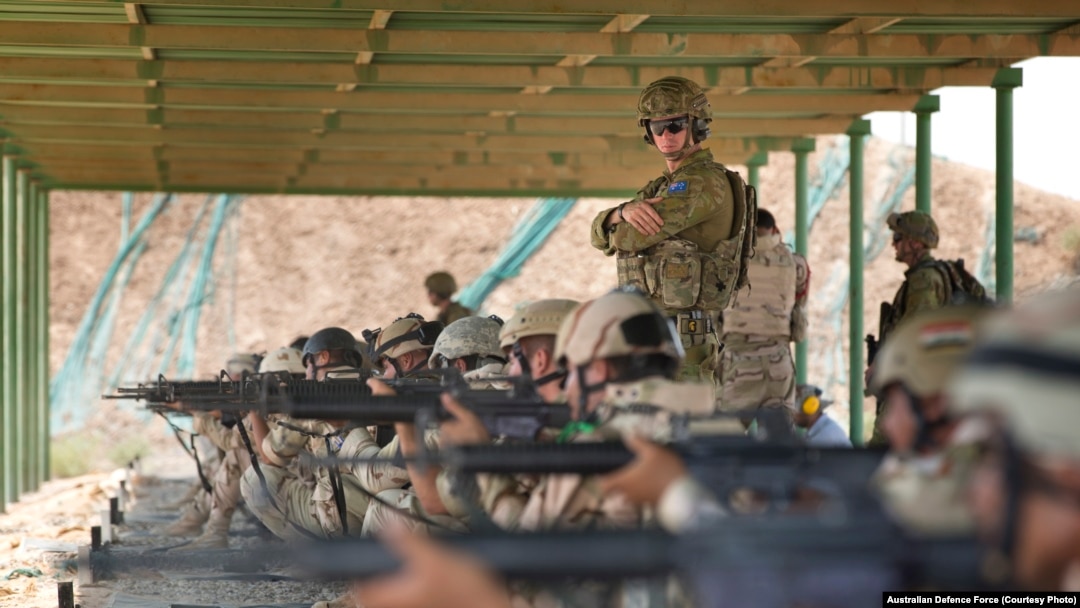 Task Group Taji Australian Army trainer Corporal Benjamin Wallis instructs regular Iraqi Army soldiers during a live-fire range shoot at the Taji Military Complex in Iraq.