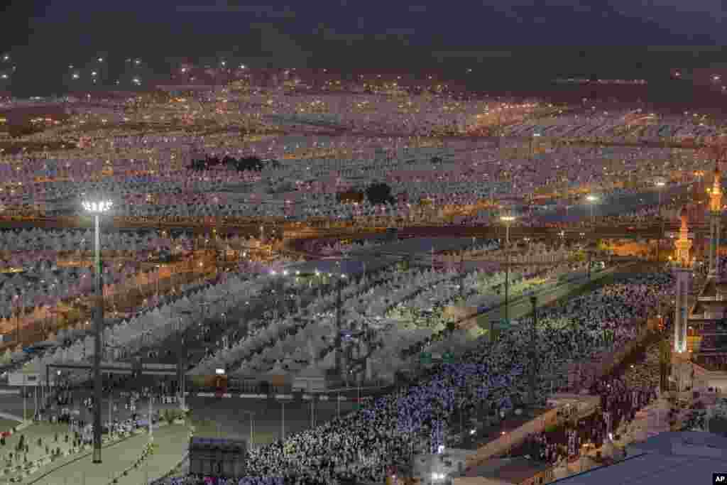 Muslim pilgrims walk back to their tents after casting stones at three huge stone pillars in the symbolic stoning of the devil during the annual hajj pilgrimage in Mina, outside the holy city of Mecca, Saudi Arabia.