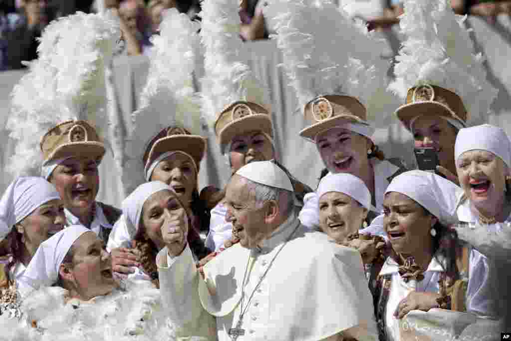 Pope Francis sings with a group of Mexican pilgrims at the end of his weekly general audience, St. Peter's Square, at the Vatican.