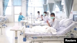 A screen grab shows boys rescued from the Thai cave wearing mask and resting in a hospital in Chiang Rai, Thailand from a July 11, 2018 handout video. (Government Public Relations Department (PRD) and Government Spokesman Bureau/Handout) 
