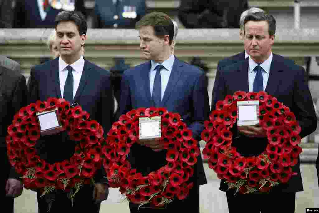 Britain's Prime Minister David Cameron (R) stands with former former Liberal Democrat leader Nick Clegg (C) and former Labour Party leader Ed Miliband, as they line up to pay tribute at the Cenotaph during a Victory in Europe (VE) day ceremony in central London, May 8, 2015.