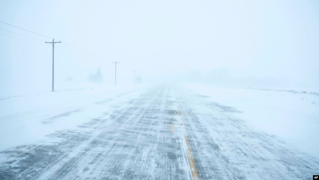 Snow blows and drifts over County Road K22 near Merrill, Iowa, on Jan. 12, 2024.