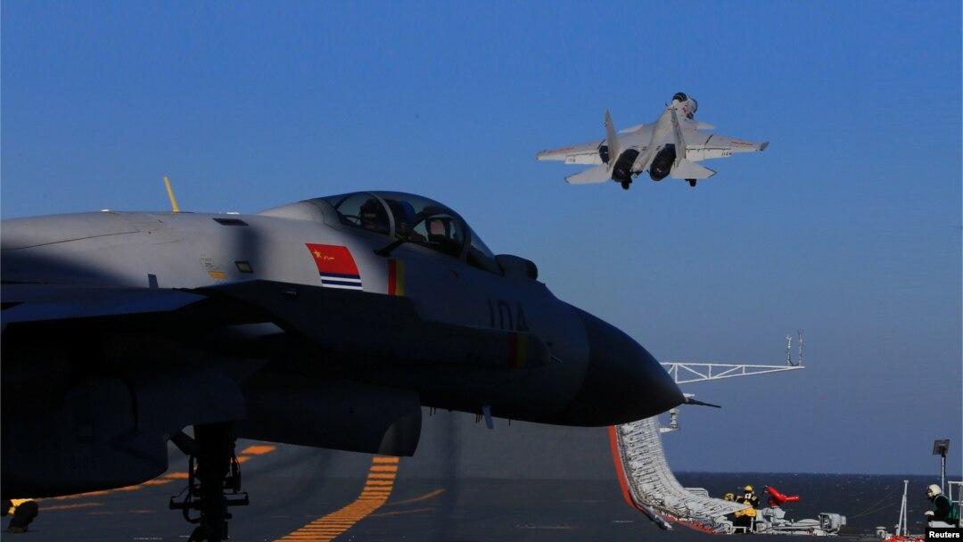 FILE - A live-fire drill using a Chinese aircraft carrier and jets is carried out in the Bohai sea, China.