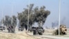 As IS mortars rain down, soldiers in military vehicles await orders to charge to the front line in Mosul, Iraq, Feb. 25, 2017. (H. Murdock/VOA)