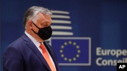 Hungary's Prime Minister Viktor Orban arrives to the main meeting room during an EU summit at the European Council building in Brussels, Thursday, June 24, 2021. (Olivier Hoslet, Pool Photo via AP)