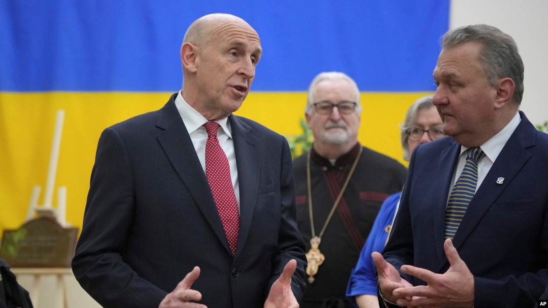 Britain's Defence Secretary John Healey, left, speaks to members as he visits the Ukrainian Catholic Church in central London, Nov. 19, 2024 to mark the 1000 days since Russia's invasion of Ukraine.