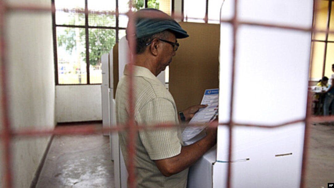 An East Timorese voter checks his ballot at a polling station during the presidential election in Dili, March 17, 2012.