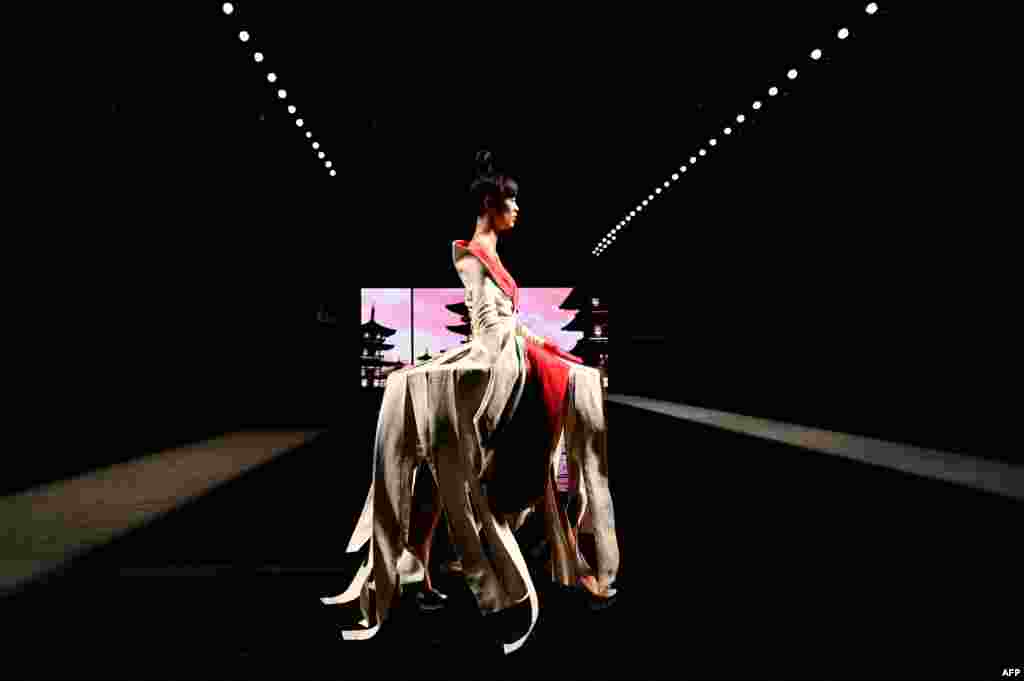 A model presents a creation of Spanish designer Andres Sarda's Spring/Summer 2022 collection during the Mercedes Benz Fashion Week in Madrid, Spain.