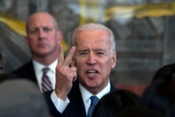 Then-U.S. Vice President Joe Biden speaks as he meets visa applicants at the U.S. Embassy Consular Section in Beijing, Dec. 4, 2013.
