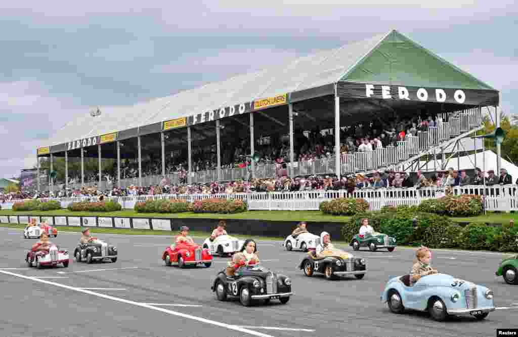 Children compete in a pedal car race as enthusiasts attend the Goodwood Revival, a three-day classic car racing festival celebrating the mid-twentieth century heyday of the sport, at Goodwood in southern Britain.