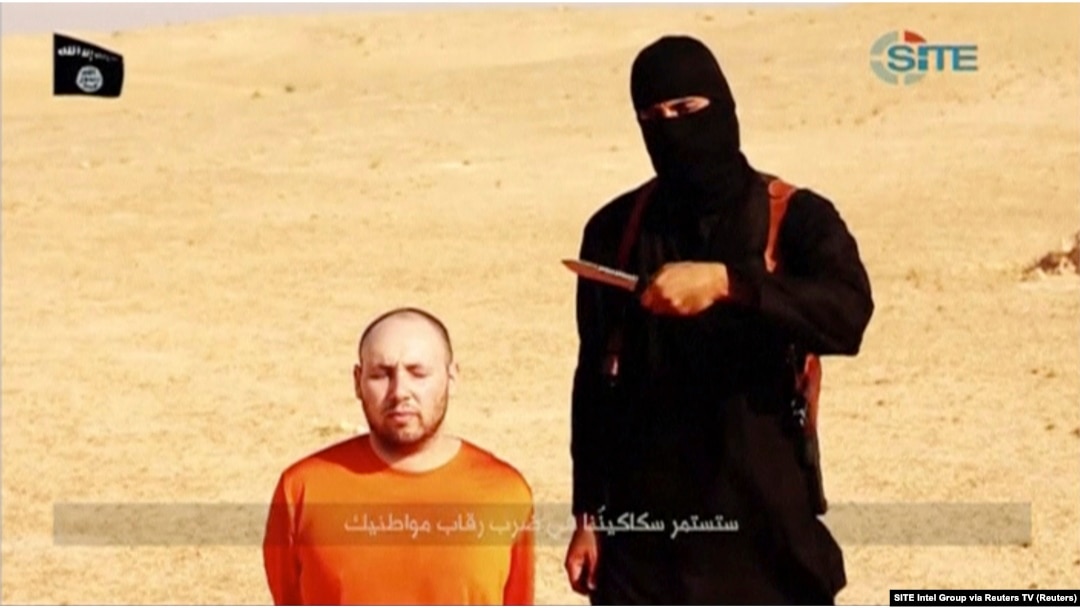FILE - “Jihadi John” stands next to a man purported to be Steven Sotloff in this still image from a video obtained from SITE Intel Group website, Feb. 26, 2015.