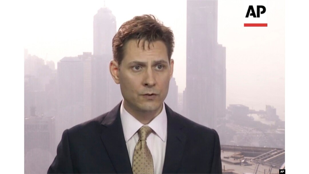 FILE - In this image made from a video taken on March 28, 2018, North East Asia senior adviser Michael Kovrig speaks during an interview in Hong Kong.