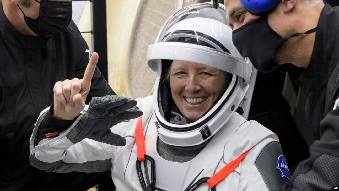 NASA astronaut Shannon Walker is helped out of the SpaceX Crew Dragon Resilience spacecraft onboard the SpaceX GO Navigator recovery ship after he and other astronauts landed in the Gulf of Mexico, May 2, 2021. (Bill Ingalls/NASA via AP)