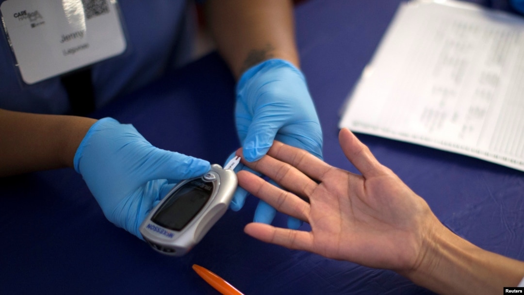 FILE - A person receives a test for diabetes at a free medical clinic in Los Angeles, California, Sept. 11, 2014. 