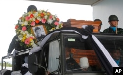 The body of Saman Gunan, a former Thai navy SEAL who died during a mission, is carried during a repatriation and religious rites ceremony at Chiang Rai Airport in Mae Sai, Chiang Rai province, in Thailand, July 6, 2018.