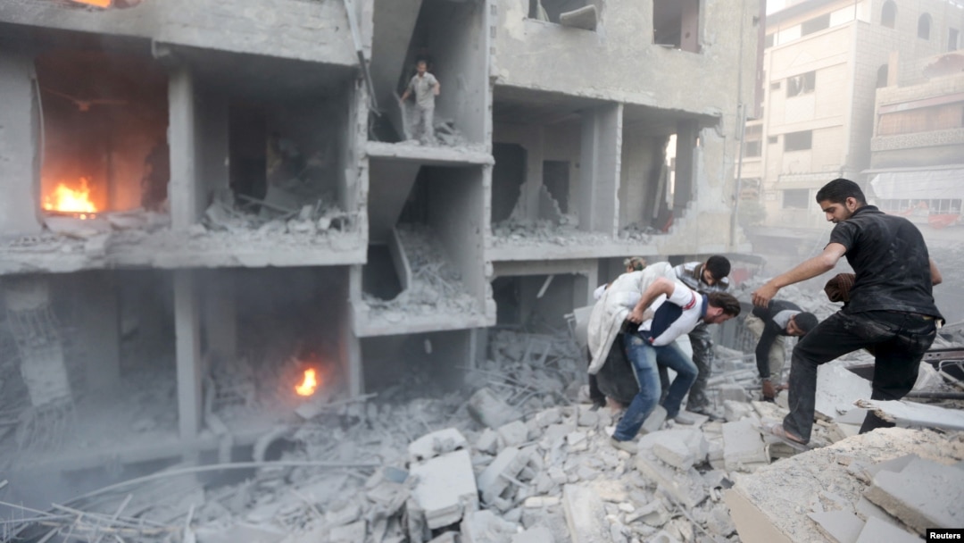 Men search for survivors at a site activists said was hit by heavy shelling by forces loyal to Syria's President Bashar al-Assad in the Douma neighborhood of Damascus June 16, 2015.