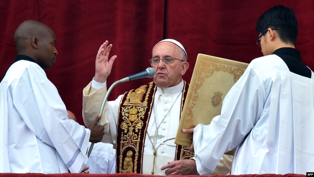 Pope Francis gives his traditional Christmas "Urbi et Orbi" blessing from the balcony of St. Peter's Basilica at the Vatican, Dec. 25, 2014.