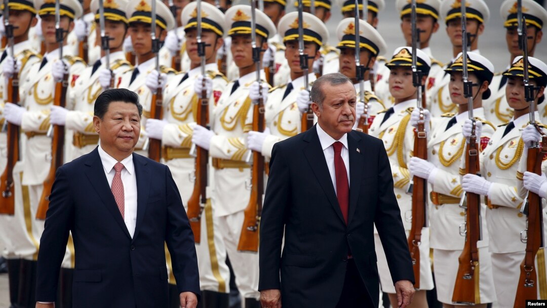 Turkey's President Recep Tayyip Erdogan, right, and his Chinese President Xi Jinping inspect honor guards during a welcoming ceremony outside the Great Hall of the People in Beijing, July 29, 2015.
