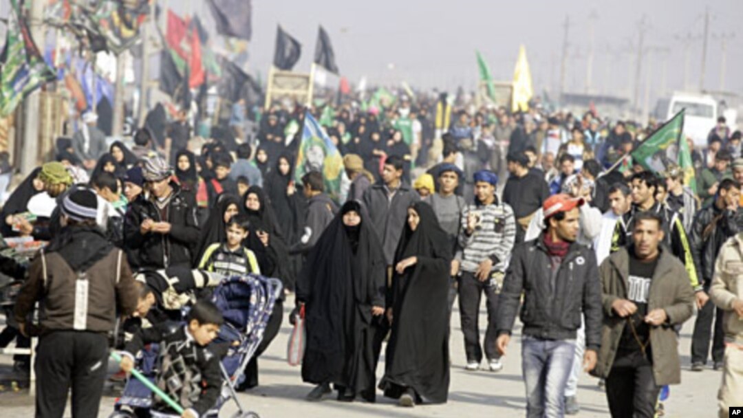 Shiite pilgrims march on their way to Karbala for Arbaeen in Baghdad, Iraq, January 9, 2012
