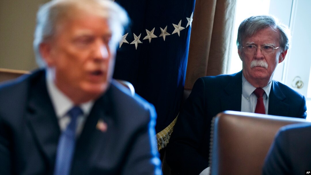 FILE - National security adviser John Bolton listens as President Donald Trump speaks during a cabinet meeting at the White House in Washington, April 9, 2018.