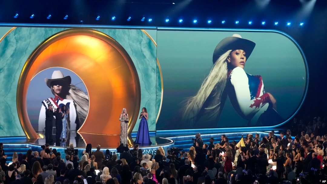 Beyonce accepts the award for album of the year for Cowboy Carter during the 67th annual Grammy Awards on Sunday, Feb. 2, 2025, in Los Angeles. Blue Ivy Carter looks on from right.