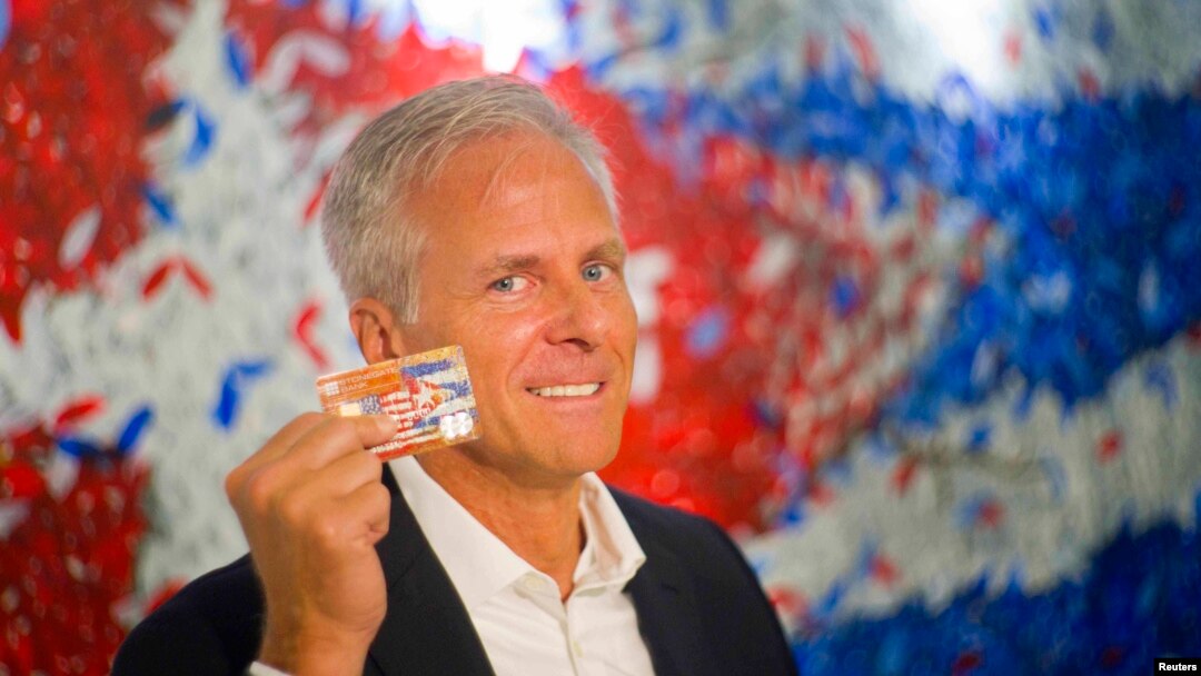 FILE - Stonegate Bank President David Seleski shows off a credit card during an interview in Havana, Cuba, June 8, 2016. 