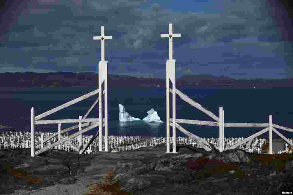 An iceberg is seen at the shore of a graveyard in Nuuk, Greenland, Sept. 13, 2021.