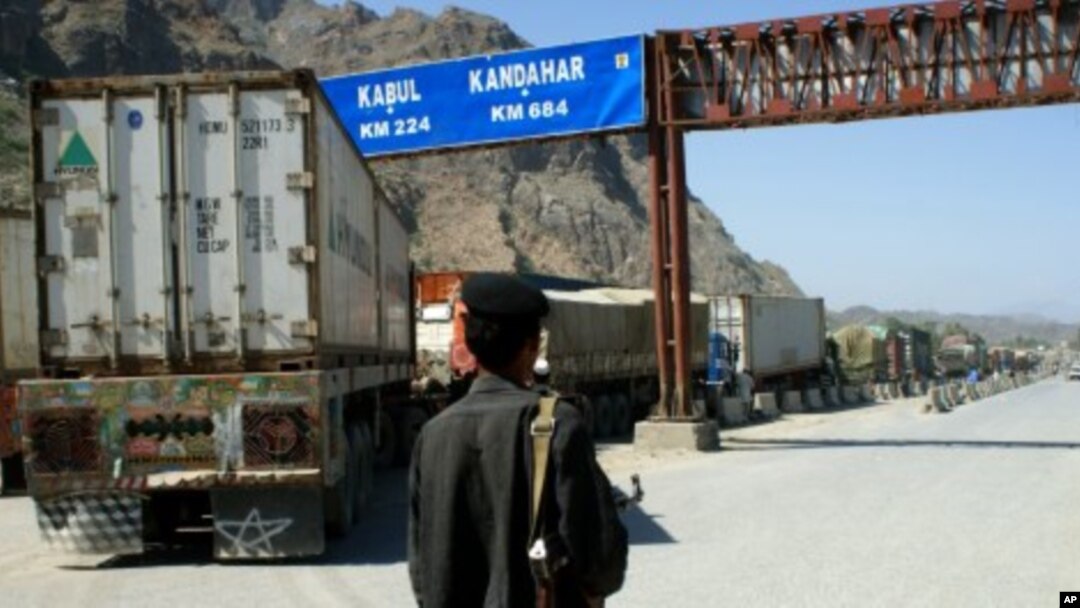 A Pakistani border guard stands near Afghanistan-bound NATO trucks parked on the roadside in Pakistani tribal area of Khyber. (File Photo)