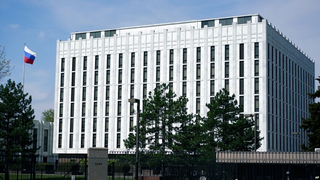 The Russian flag flies on the grounds of the Embassy of the Russian Federation in Washington, Thursday, April 15, 2021. The Biden administration has rolled out a sweeping set of sanctions on Russia over its election interference, hacking efforts and…